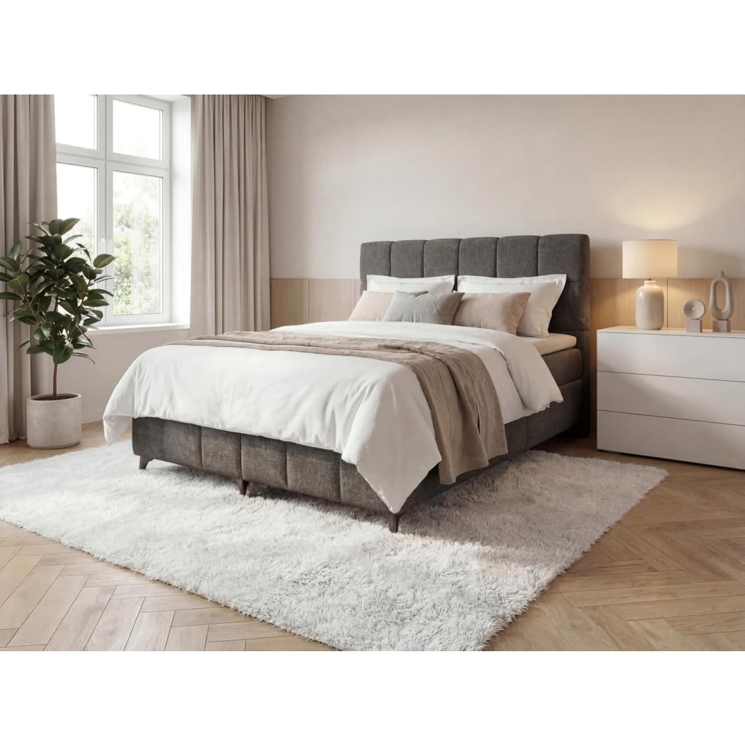 Boxspringbett in Grau mit einem Bettkasten